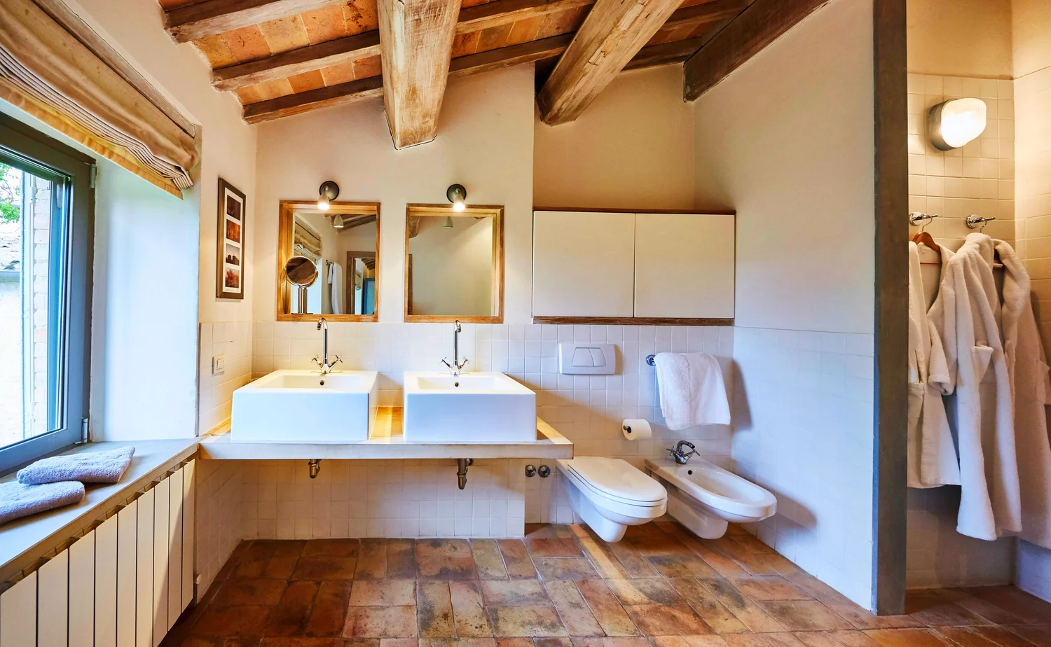 Master shower room with twin basins and countryside views